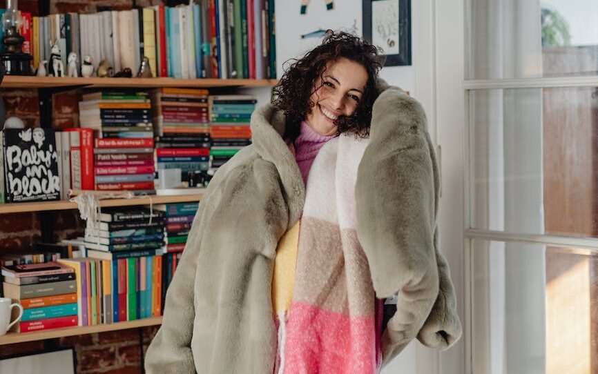 woman with warm clothes on in home