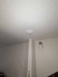 Water draining from a water bubble in the ceiling from a leaking pipe in the apartment above.